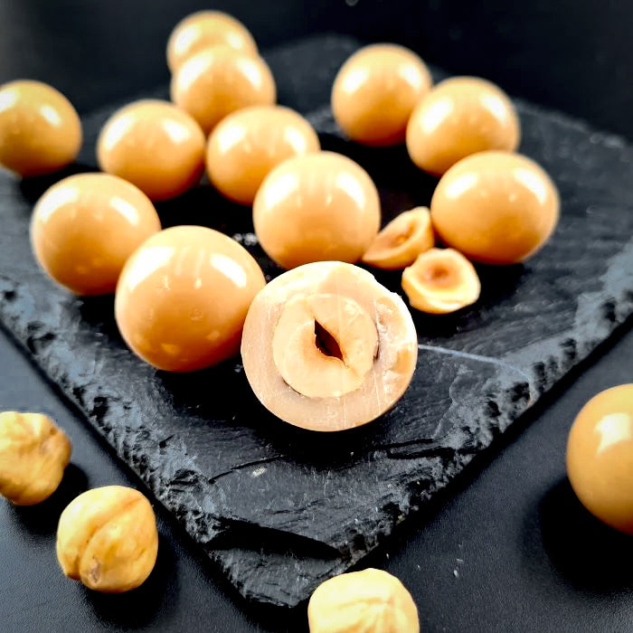 Kapučino dražejas ar lazdu riekstiem baltā beļģu šokolādē